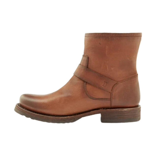 Brown leather ankle boot with a low heel and diagonal strap across the shaft