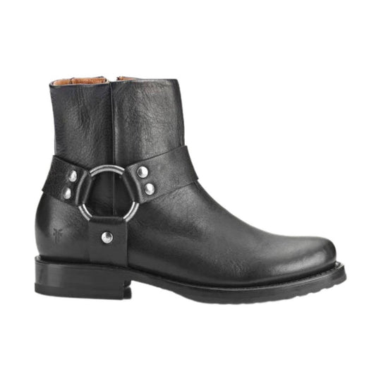 Black ankle boot with harness strap, silver ring detail, and low block heel
