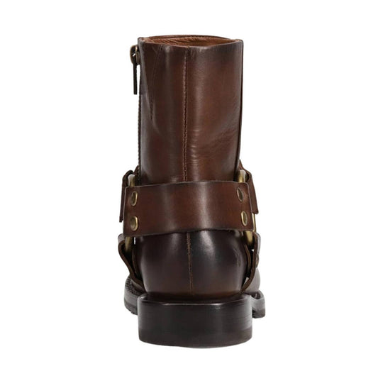 Brown leather ankle boot seen from the back with a pull zipper, harness strap, and chunky heel