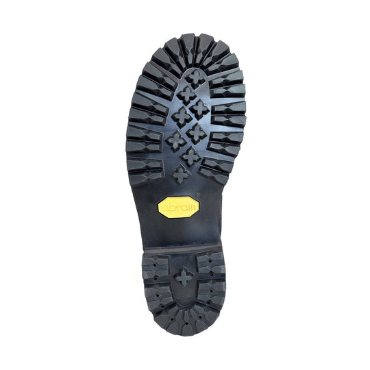 Black lugged boot outsole with yellow Vibram logo