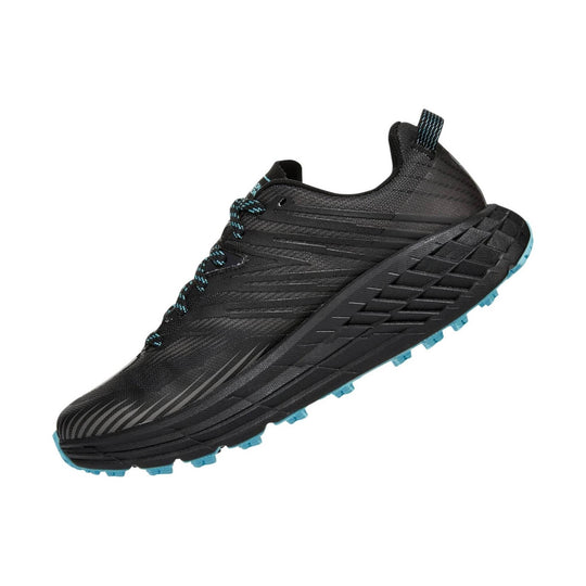 Black trail running shoe with blue laces and blue outsole lugs, shown in side view.