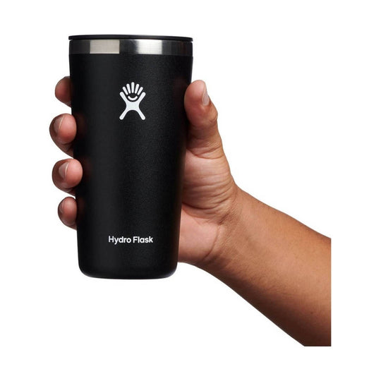 Black insulated tumbler with stainless steel rim, shown in a hand
