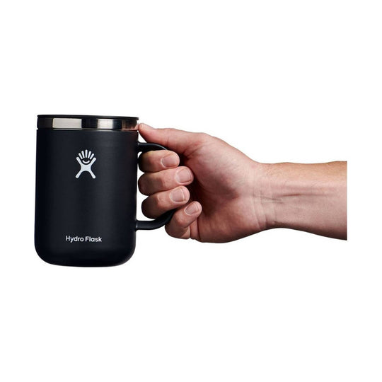 Black insulated mug with a handle and stainless steel lid, shown in hand