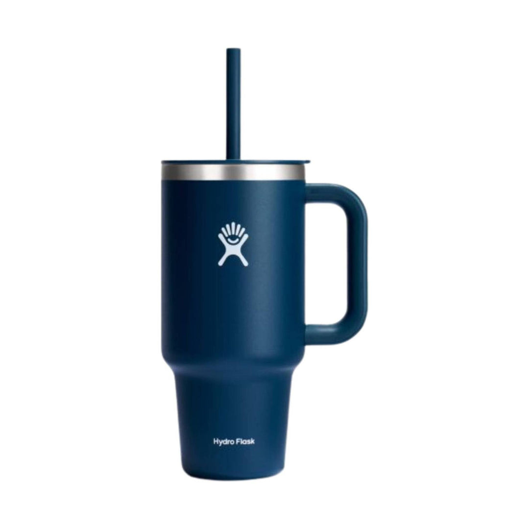 Dark blue handled travel tumbler with lid and straw, plus a white logo on the front