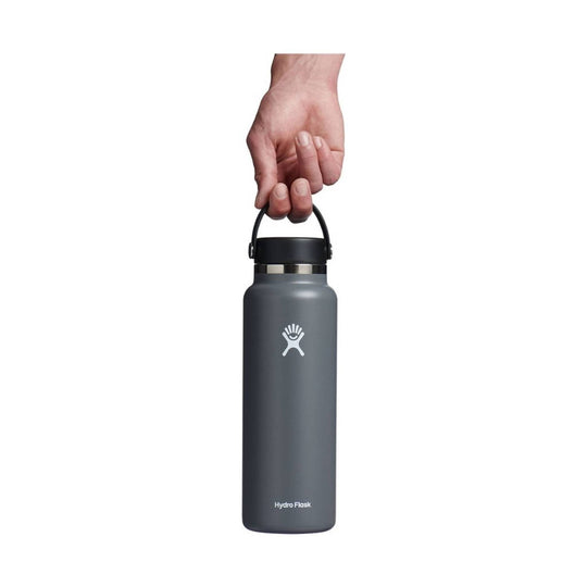 Dark gray insulated water bottle with loop cap and Hydro Flask logo, held by a hand