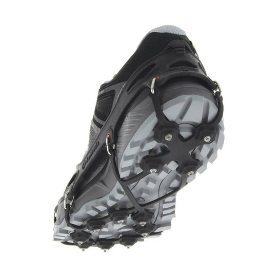 Black hiking shoe sole with removable traction spikes and a gray lugged outsole, shown from below