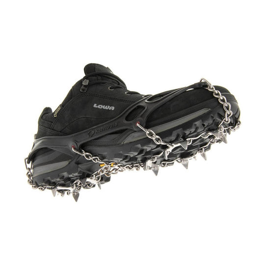 Black hiking boot fitted with metal traction chains and spikes, shown from the sole