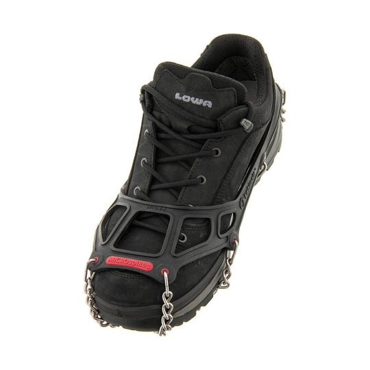 Black hiking shoe with traction chains and a red Microspikes toe strap