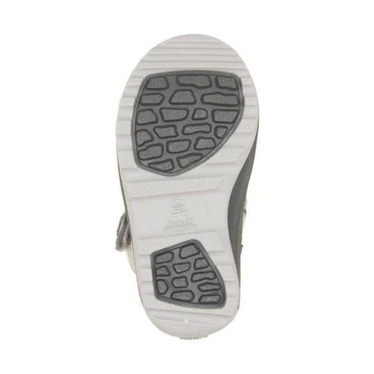 Boot sole with white ridged tread and dark rubber traction pods