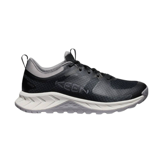 Black and gray low-top trail shoe with mesh upper, laces, and thick white midsole