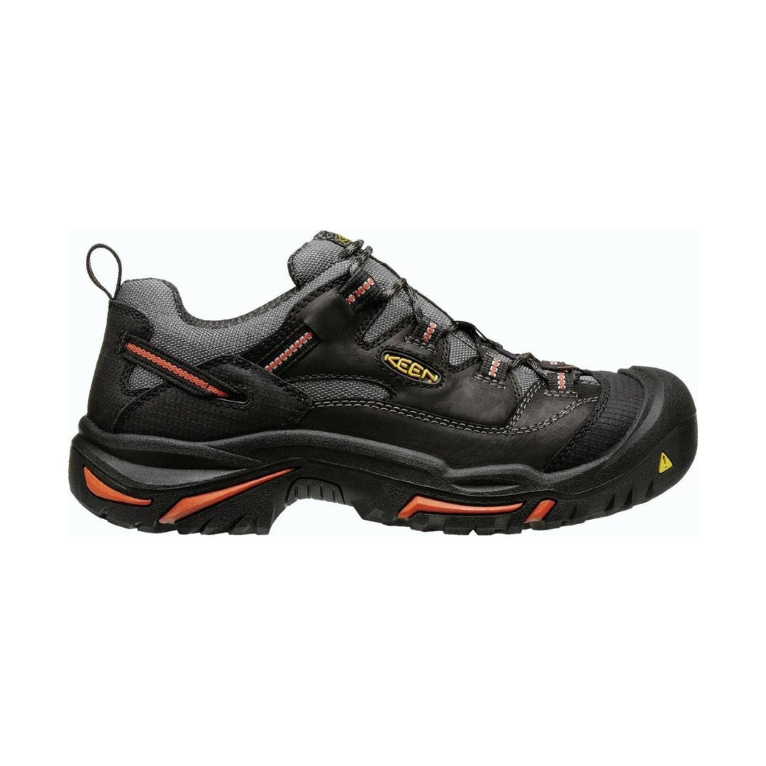 Black low-top work shoe with gray mesh panels, orange accents, and a thick treaded sole