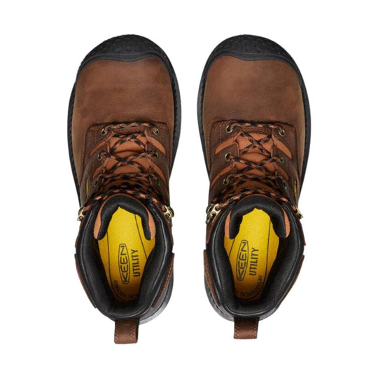 Brown and black lace-up work boots with yellow insoles, viewed from above
