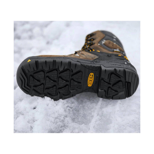 Black and brown insulated work boot shown from the sole, with rugged tread and KEEN logo.