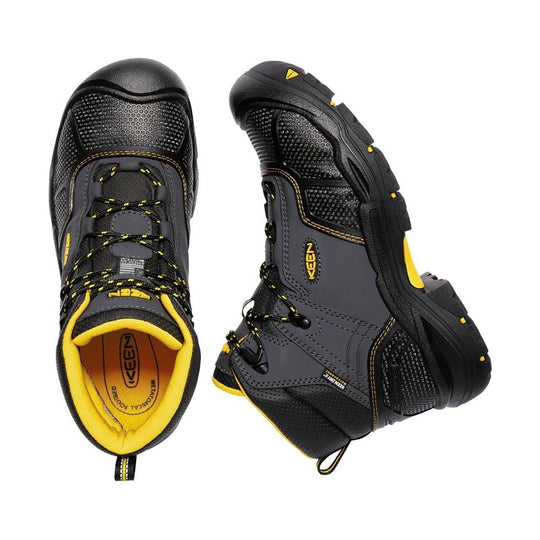 Black and gray mid-cut work boot with yellow accents, mesh panels, and a rugged lug sole