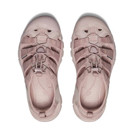 Pair of blush pink closed-toe hiking sandals with bungee laces and side cutouts