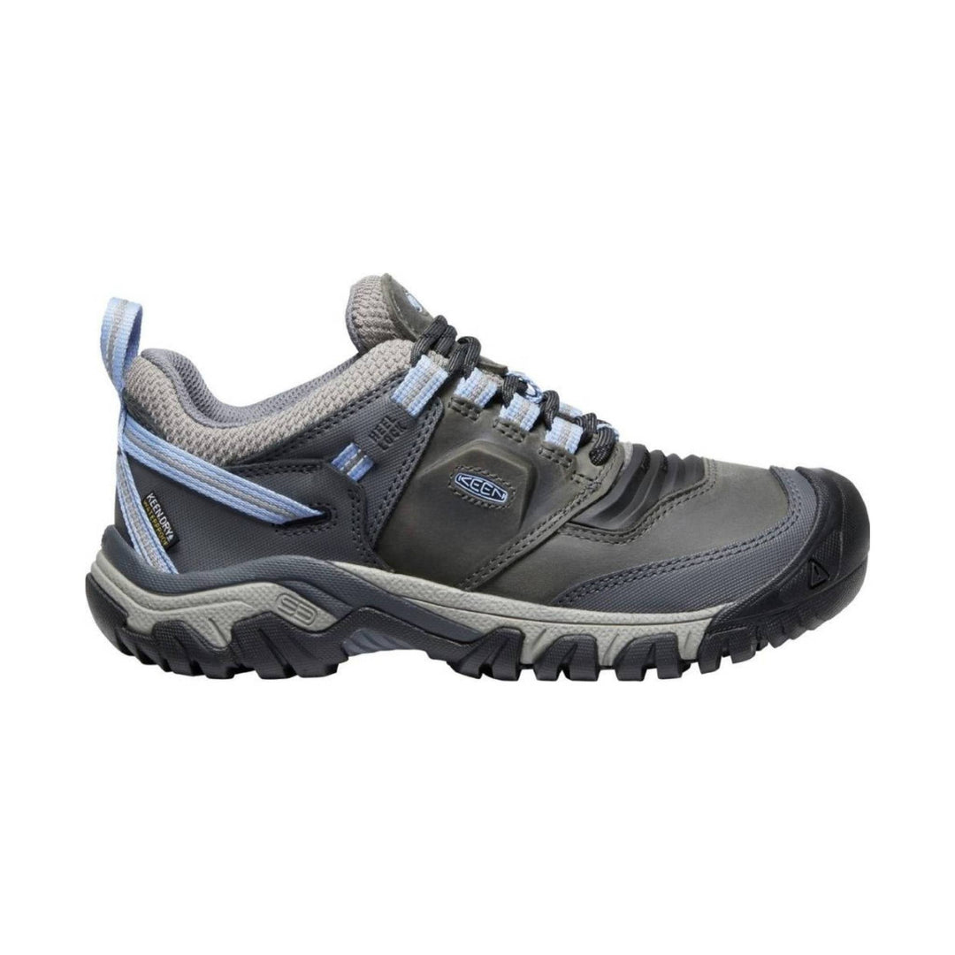 Gray low hiking shoe with light blue laces and a rugged black sole