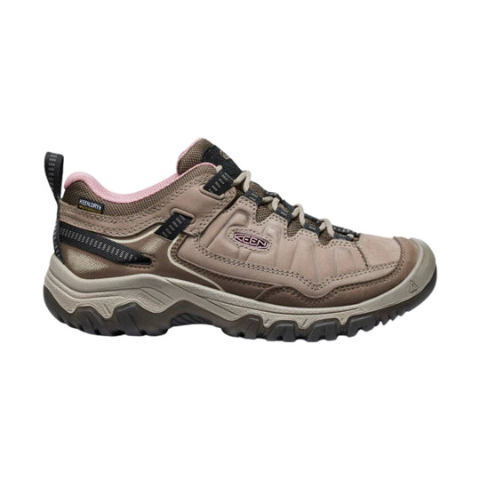 Brown and pink low hiking shoe with black laces and a rugged treaded sole