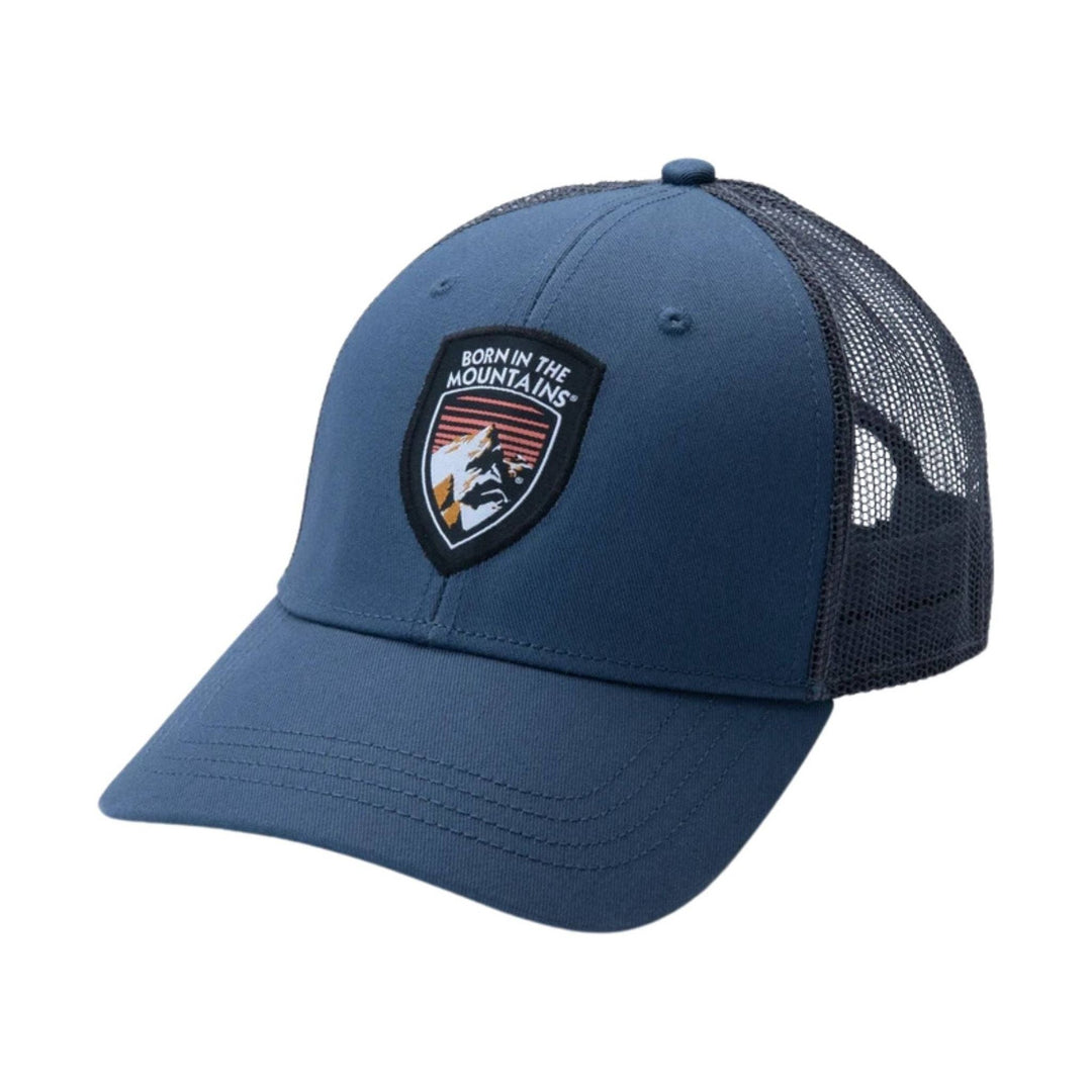 Blue trucker cap with black mesh back and mountain patch on the front