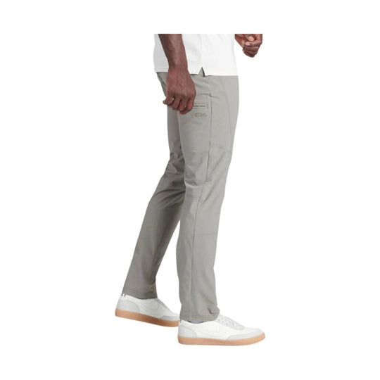 Light gray hiking pants shown on a model in side view with articulated knees and a small thigh logo