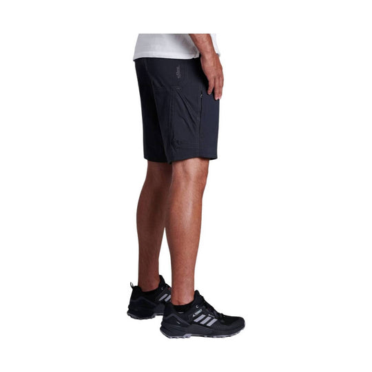 Black hiking shorts with side cargo pocket, shown on a model wearing black trail shoes.