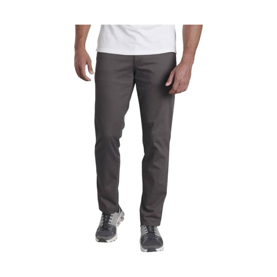 Charcoal slim-fit pants with five-pocket styling, shown on a model with a white T-shirt and gray sneakers