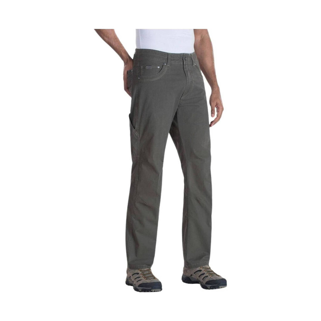 Men's dark gray straight-leg pants with five-pocket styling and hiking shoes