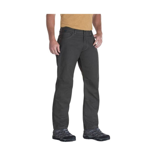 Dark gray men’s hiking pants shown on a standing model with cargo-style side pocket and outdoor shoes