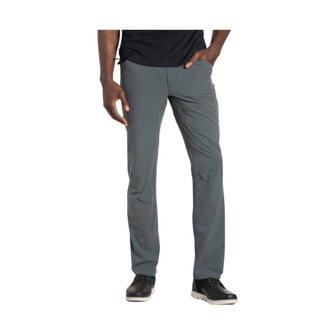 Gray straight-leg pants styled with a black shirt and black shoes