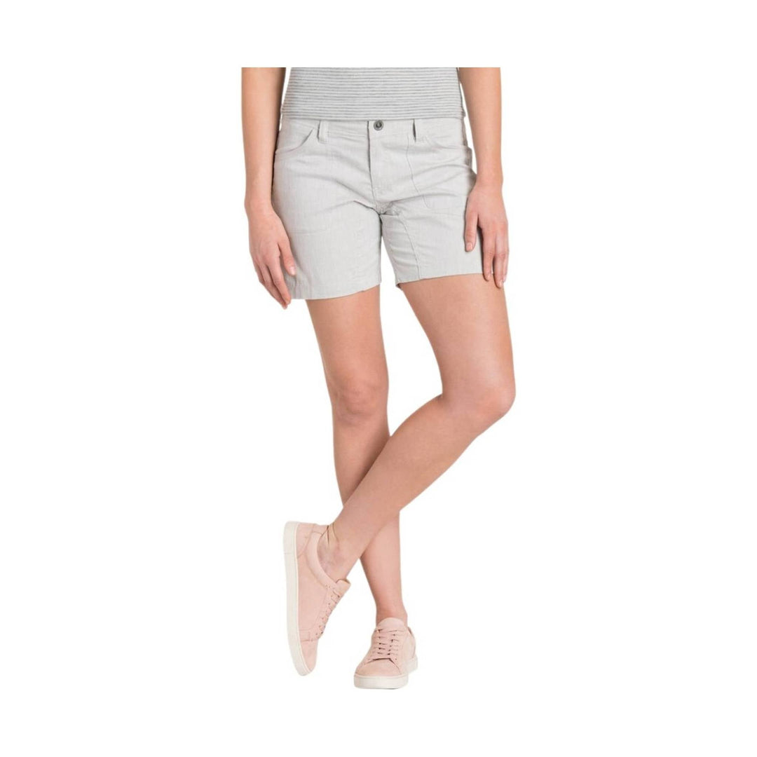 Light gray tailored shorts worn with a striped top and pink sneakers