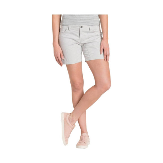 Light gray tailored shorts worn with a striped top and pink sneakers