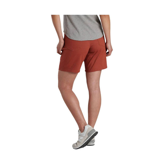Rust-colored athletic shorts shown from the back on a model