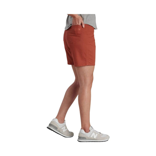 Rust-colored tailored shorts shown on a model from the side/back