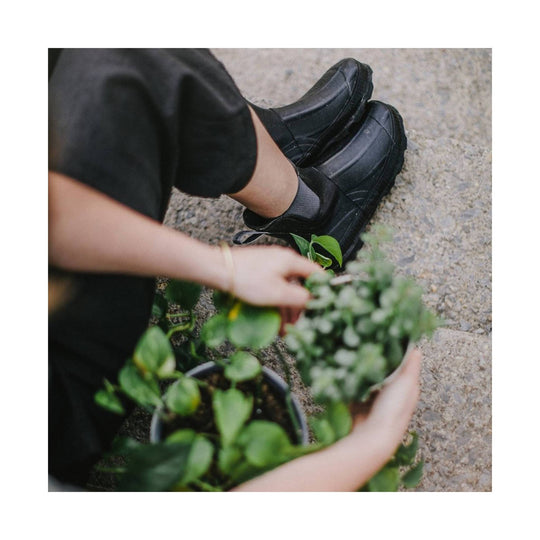 Black ankle rain boots with thick treaded soles