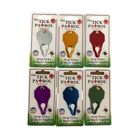 Assorted tick remover tools on retail cards in silver, gold, red, purple, blue, and green.