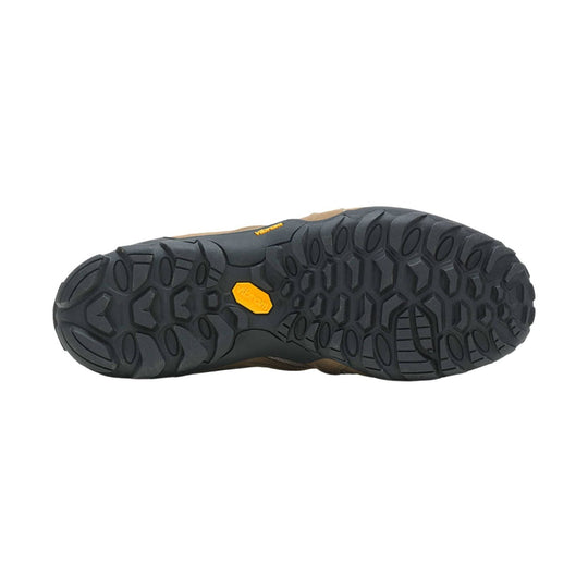 Black hiking shoe outsole with deep tread and small yellow Vibram logo