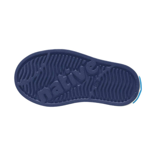 Navy kids' shoe sole with embossed Native logo and wave tread pattern