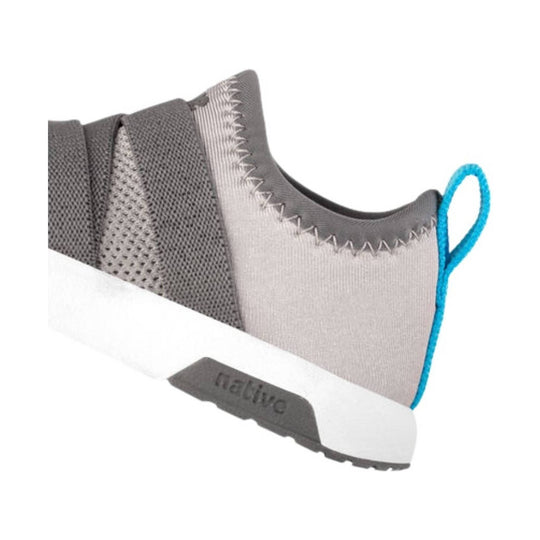 Gray toddler sneaker with mesh panels, white sole, blue heel pull tab, and visible "native" text on the sole
