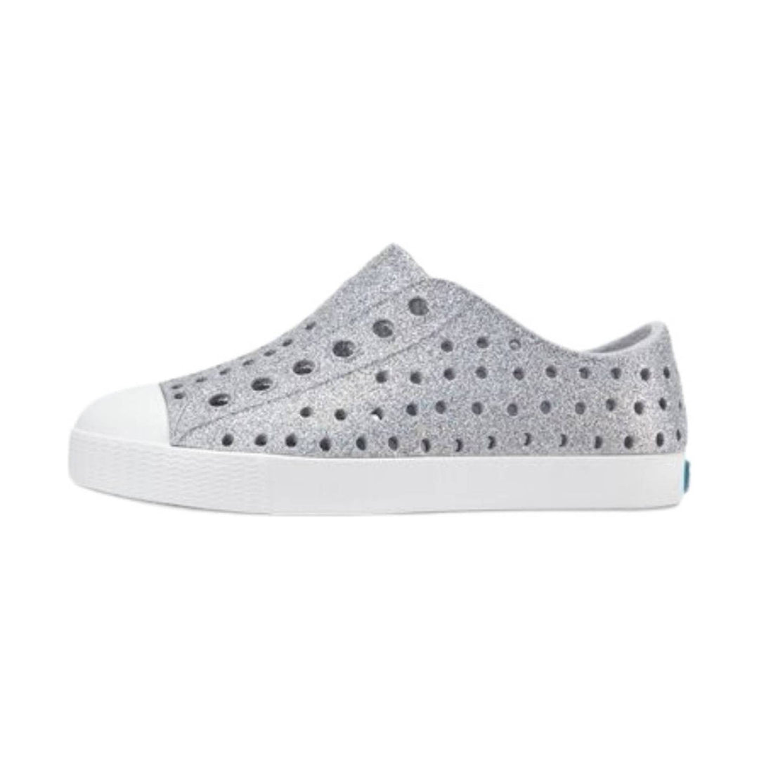 Light gray slip-on sneaker with round perforations, white rubber sole, and white toe cap