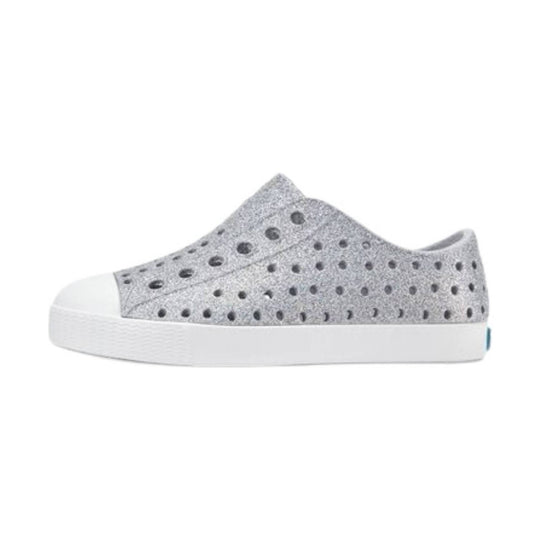 Light gray slip-on sneaker with round perforations, white rubber sole, and white toe cap