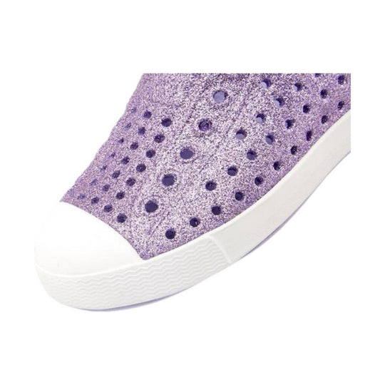 White slip-on shoe with a glittery purple upper and round perforations