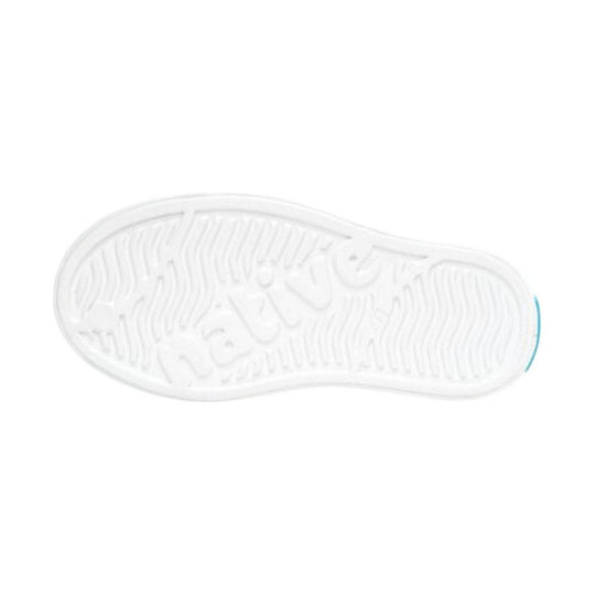White sneaker outsole with wavy tread pattern and a blue accent at the heel