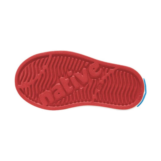Red toddler shoe sole with wavy tread and embossed lettering