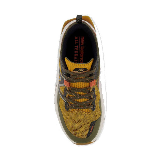 Top view of a gold, black, and olive trail running shoe with dark laces and visible New Balance branding inside.