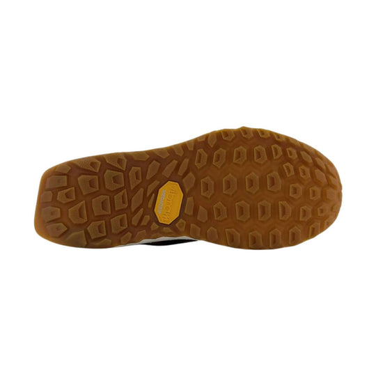 Brown lugged shoe sole with a yellow Vibram Megagrip badge