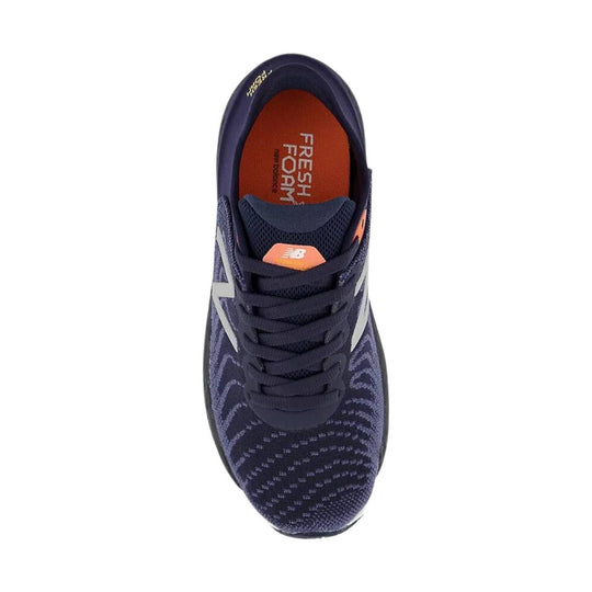 Navy running shoe with white side logo and orange insole, viewed from above