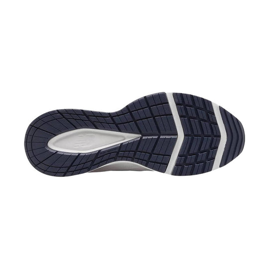 Navy and white sneaker outsole with deep tread grooves and a cushioned midfoot cutout