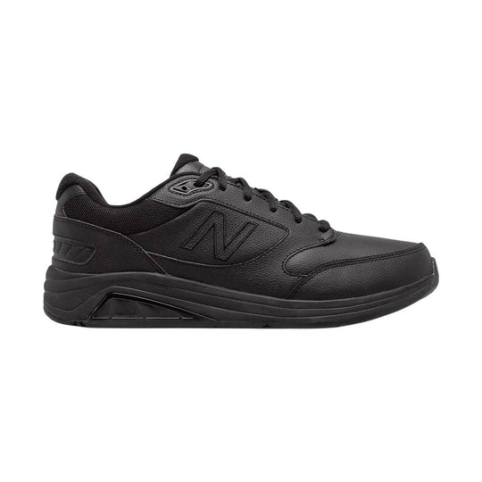 Black low-top walking shoe with leather upper, mesh collar, and thick cushioned sole
