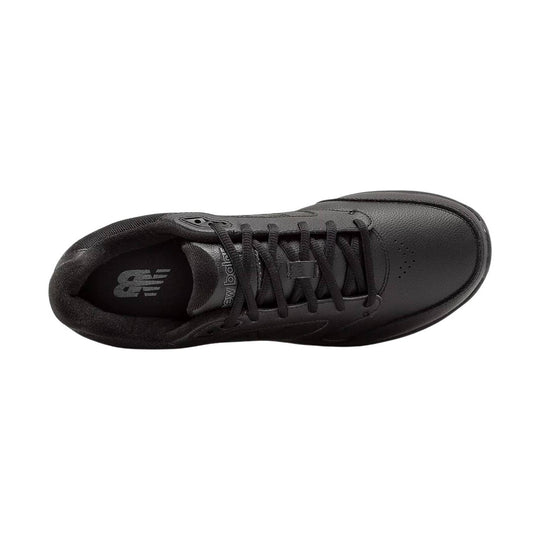 Black athletic walking shoe with lace-up closure and perforated toe box, top view