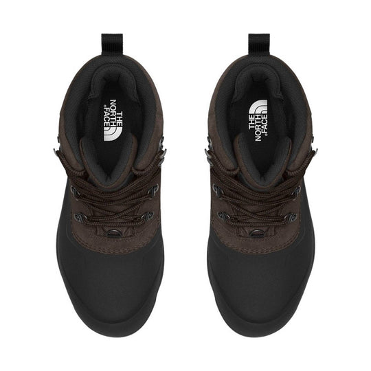 Brown and black hiking boots, top view, with laces and pull tabs