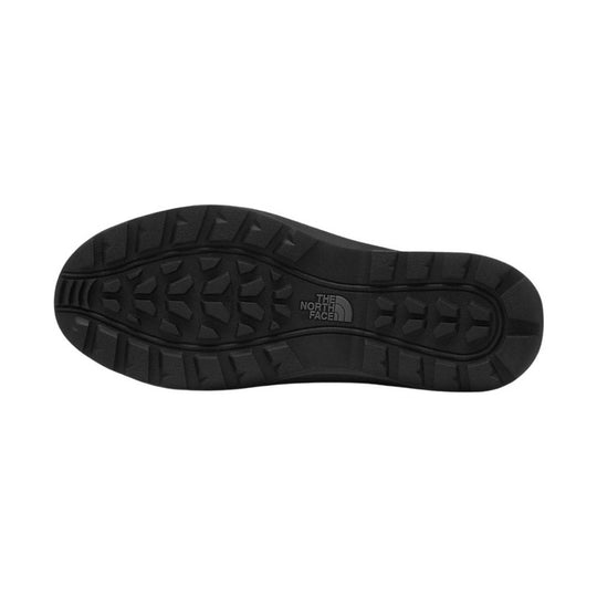 Black boot outsole with deep tread and The North Face logo at center